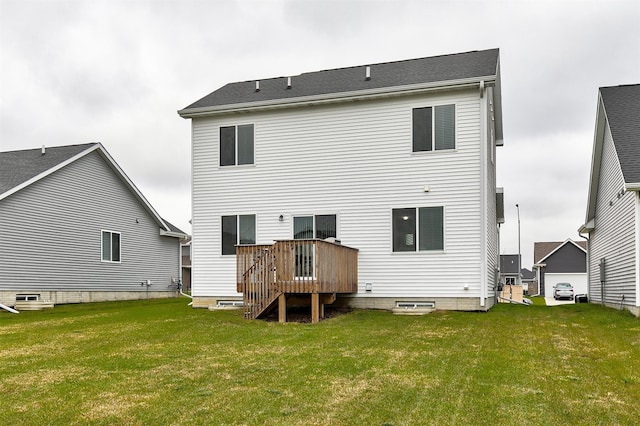 rear view of house featuring a lawn and a deck