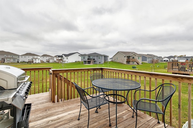 deck with a lawn and area for grilling