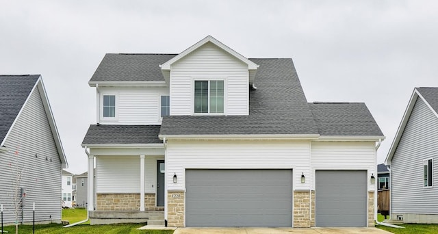 view of front facade featuring a front lawn, roof with shingles, driveway, stone siding, and an attached garage