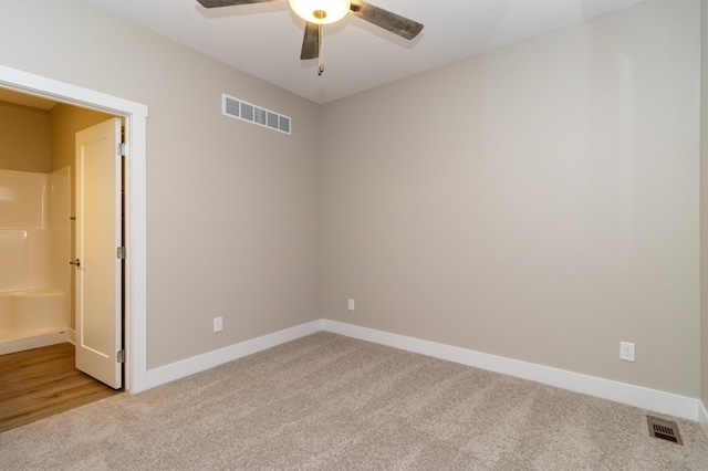 spare room featuring ceiling fan and light colored carpet