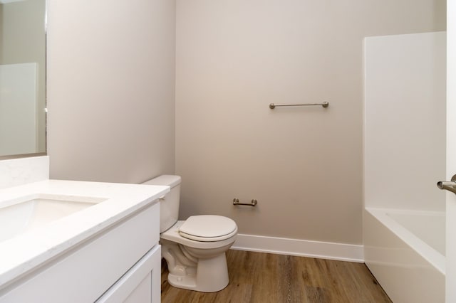 bathroom with vanity, toilet, and wood-type flooring