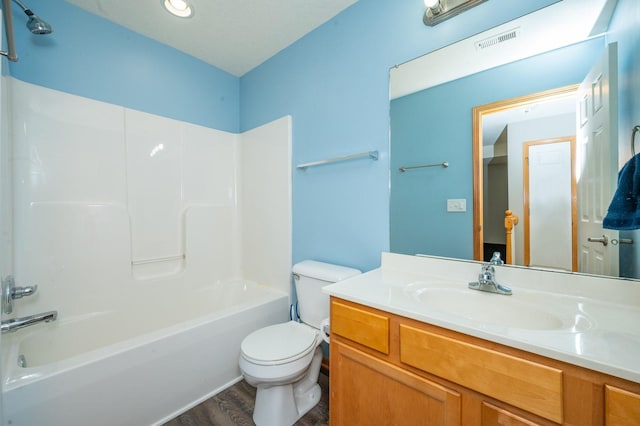 full bathroom featuring vanity, wood-type flooring,  shower combination, and toilet