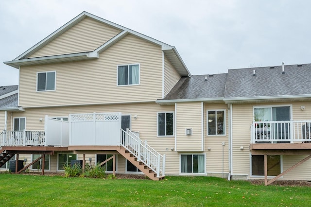 back of property featuring a yard, a deck, and cooling unit