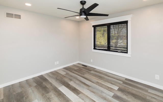 6562 Center St, West Des Moines, IA 50266 - spare room featuring a ceiling fan, wood finished floors, baseboards, and recessed lighting