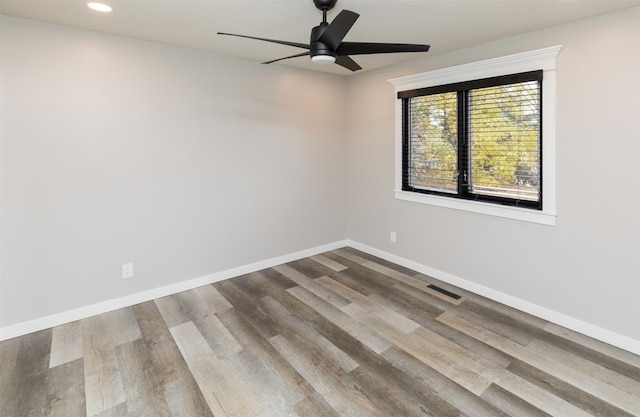 empty room featuring hardwood / wood-style floors and ceiling fan