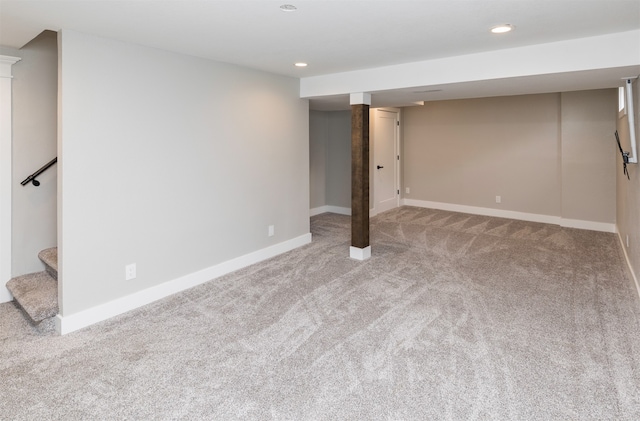 basement featuring light carpet