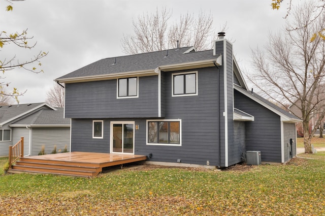 back of house with a deck, central AC unit, and a lawn