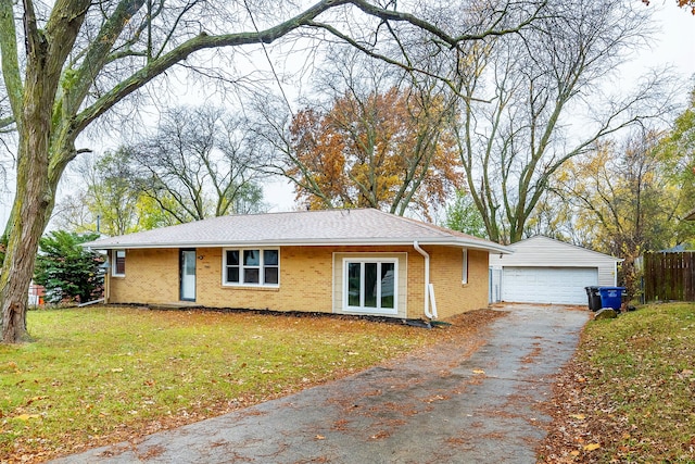 view of front facade featuring a garage, a front lawn, and an outdoor structure