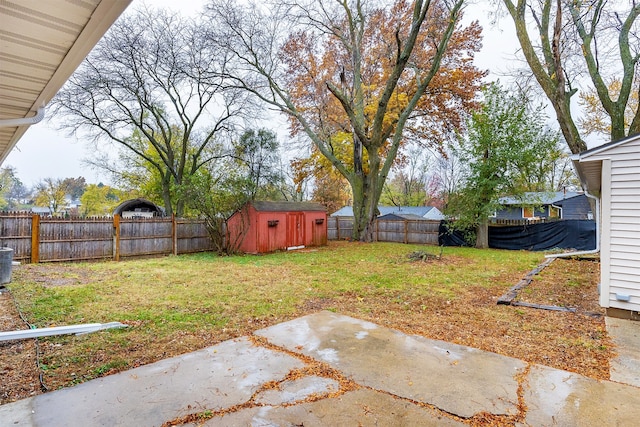 view of yard featuring central air condition unit, a patio, and a storage unit