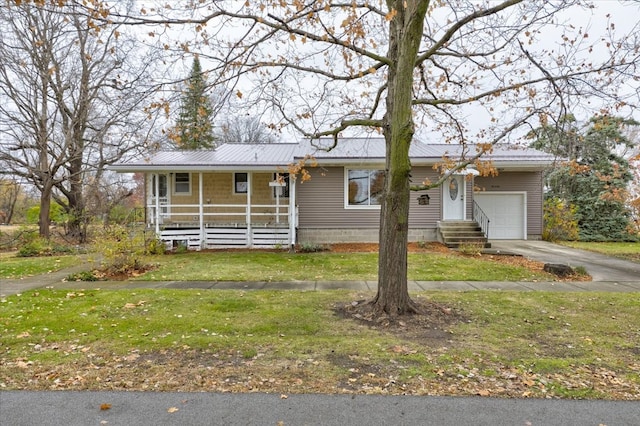 view of front of home with a front lawn and a garage