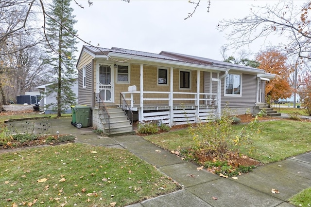 view of front of house with a porch and a front lawn