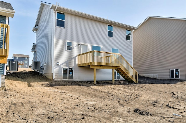 back of house featuring cooling unit and a deck