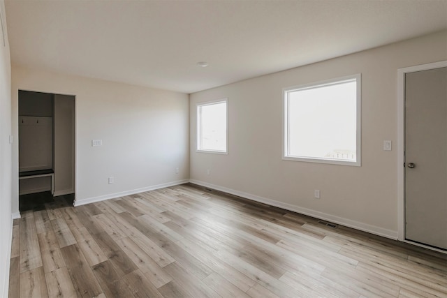 spare room with light hardwood / wood-style floors