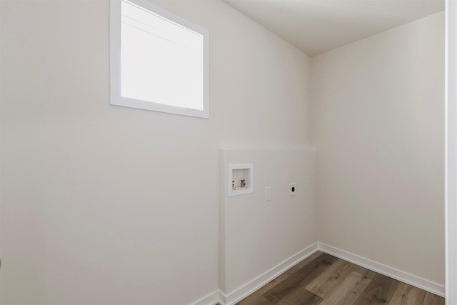 laundry room with electric dryer hookup, dark wood-type flooring, and washer hookup