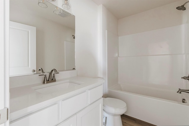 full bathroom featuring vanity, hardwood / wood-style flooring, shower / bathtub combination, and toilet