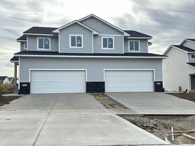 view of front of house with a garage and concrete driveway