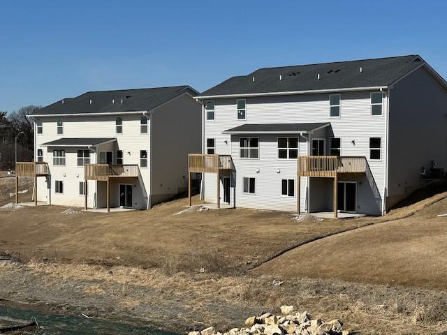 rear view of property with a wooden deck