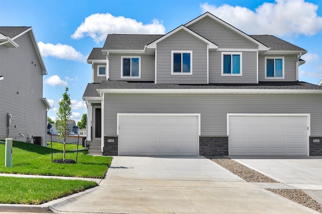 5130 Ella Ivy Ct, Van Meter, IA 50261 - craftsman inspired home with a front yard, an attached garage, driveway, and central air condition unit