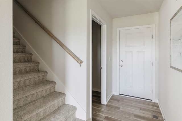 5130 Ella Ivy Ct, Van Meter, IA 50261 - staircase with wood finished floors and baseboards