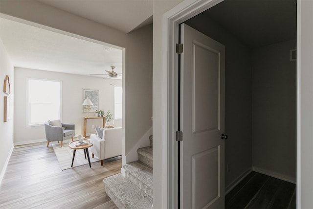 5130 Ella Ivy Ct, Van Meter, IA 50261 - corridor featuring wood finished floors, stairway, and baseboards