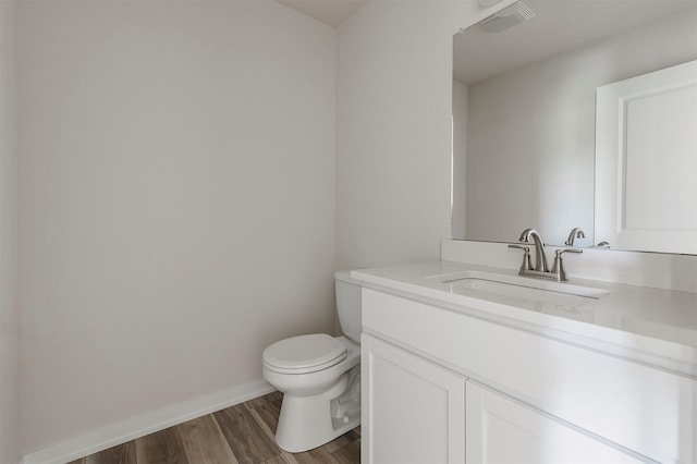 5130 Ella Ivy Ct, Van Meter, IA 50261 - bathroom with vanity, toilet, baseboards, and wood finished floors