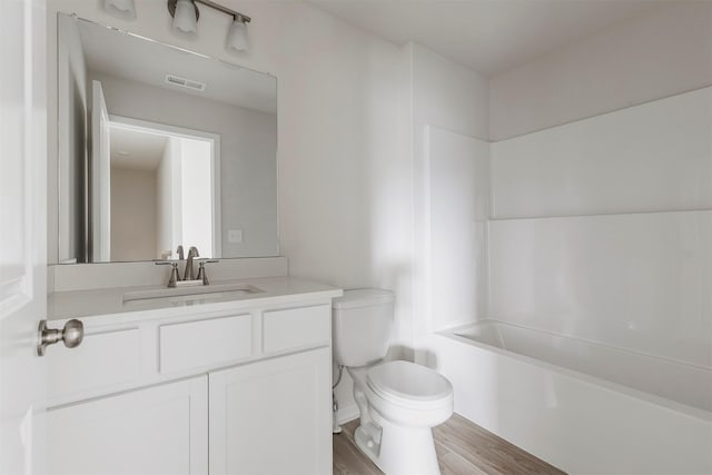 5130 Ella Ivy Ct, Van Meter, IA 50261 - bathroom with toilet, wood finished floors, vanity, and shower / tub combination