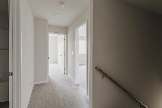 5130 Ella Ivy Ct, Van Meter, IA 50261 - corridor featuring light colored carpet, baseboards, and an upstairs landing