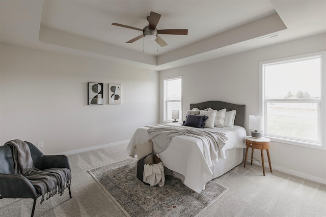 5130 Ella Ivy Ct, Van Meter, IA 50261 - bedroom with light colored carpet, a raised ceiling, baseboards, and a ceiling fan