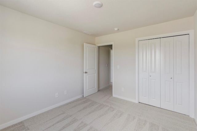 5130 Ella Ivy Ct, Van Meter, IA 50261 - unfurnished bedroom featuring baseboards, light colored carpet, and a closet