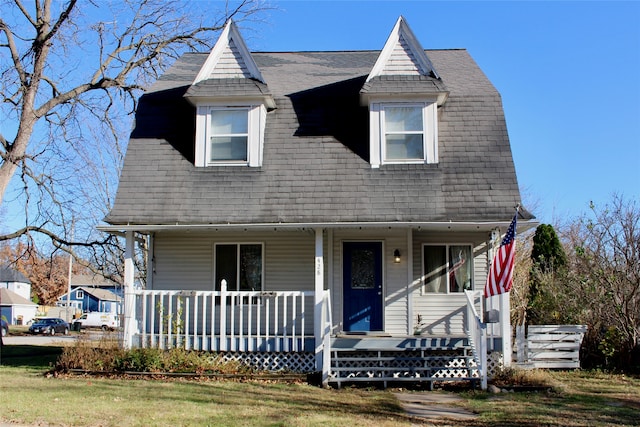 view of front facade with a front yard and a porch