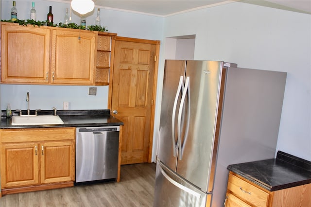 kitchen featuring sink, appliances with stainless steel finishes, and light hardwood / wood-style flooring