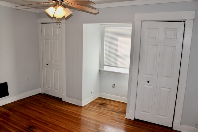 unfurnished bedroom featuring dark hardwood / wood-style floors and ceiling fan