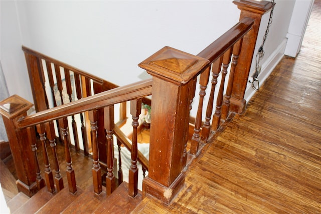 stairway featuring wood-type flooring