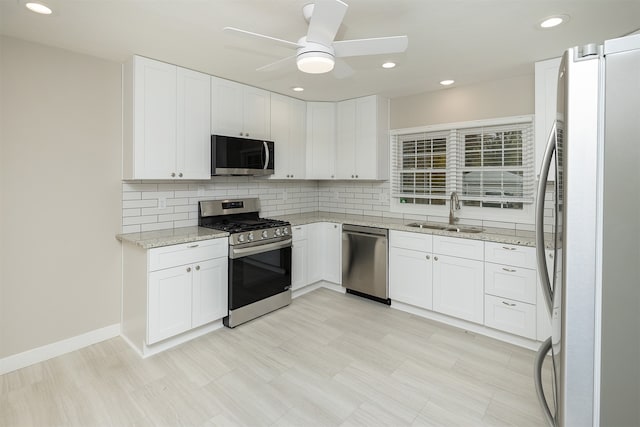 kitchen with white cabinetry, sink, and appliances with stainless steel finishes