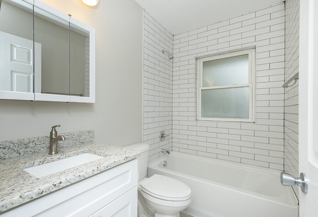 full bathroom with toilet, vanity, and tiled shower / bath