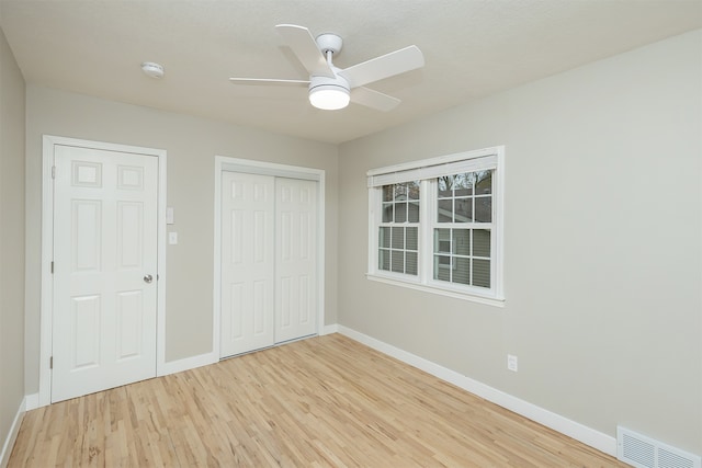 unfurnished bedroom with light hardwood / wood-style floors and ceiling fan