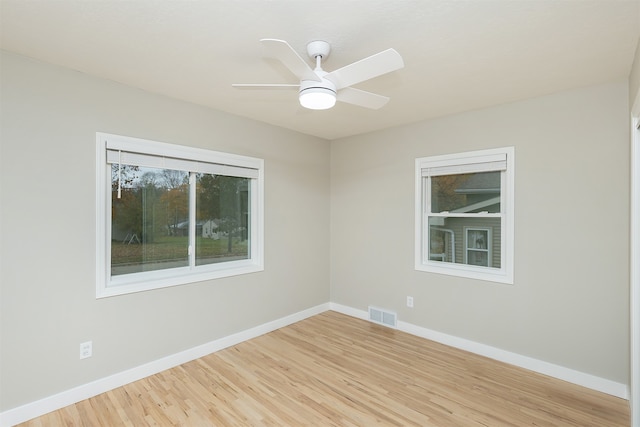 spare room with light hardwood / wood-style flooring and ceiling fan