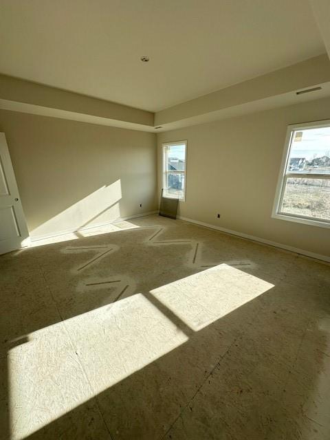 unfurnished room with visible vents and baseboards