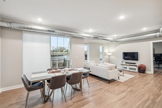 dining area with baseboards and light wood-style floors