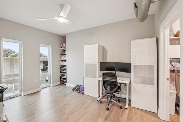 office area featuring light wood-style flooring, baseboards, and a ceiling fan