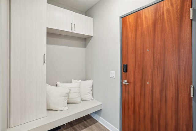 mudroom featuring wood finished floors and baseboards