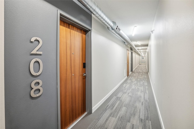 450 SW 7th St Unit 208, Des Moines, IA 50309 - hallway with baseboards and wood finished floors