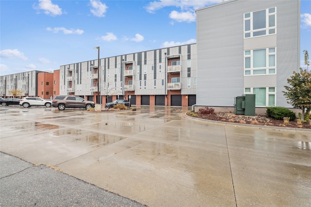 450 SW 7th St Unit 208, Des Moines, IA 50309 - view of apartment building / complex featuring uncovered parking