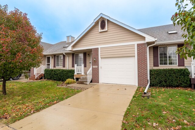 ranch-style home featuring a front lawn and a garage