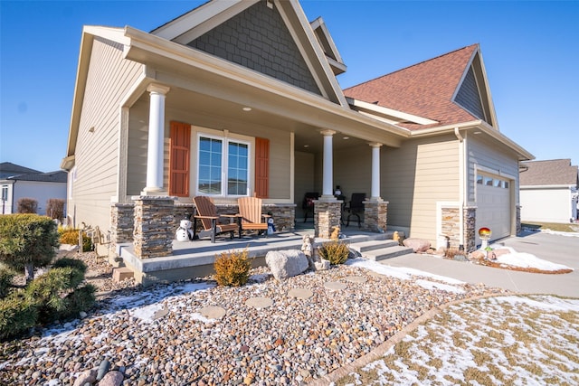 craftsman house with a porch and a garage