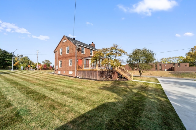 exterior space featuring a deck and a lawn