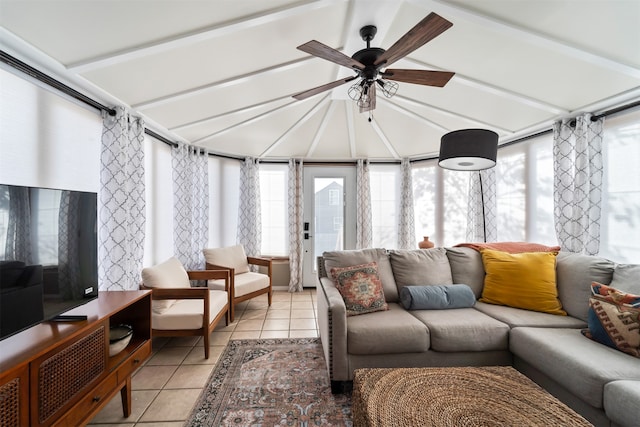 sunroom featuring vaulted ceiling with beams, ceiling fan, and plenty of natural light