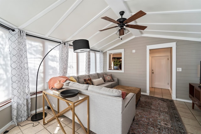 living room featuring lofted ceiling with beams, tile patterned floors, ceiling fan, and wood walls