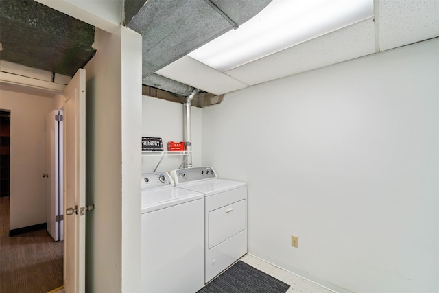 clothes washing area featuring washer and clothes dryer