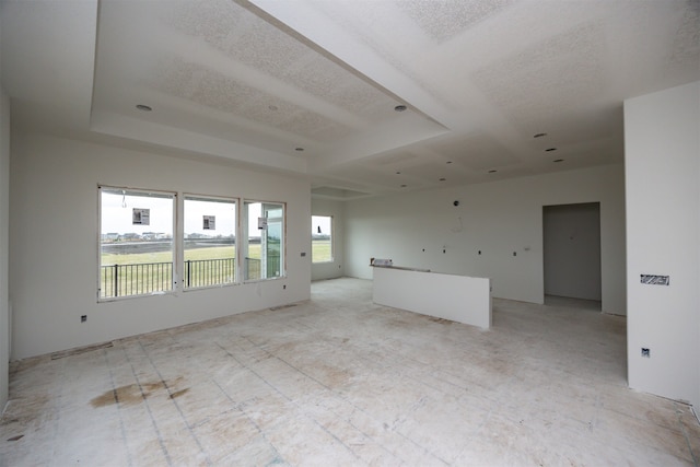 empty room featuring a tray ceiling